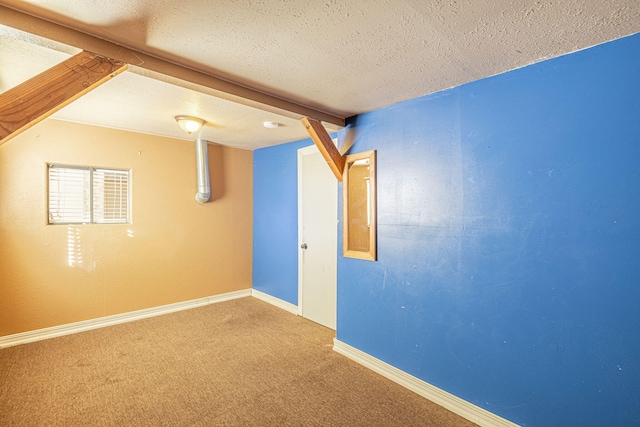 basement with carpet and a textured ceiling