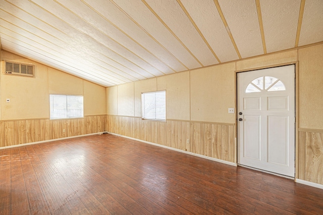 entrance foyer with wood-type flooring and vaulted ceiling