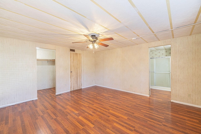 unfurnished bedroom featuring dark hardwood / wood-style flooring and ceiling fan