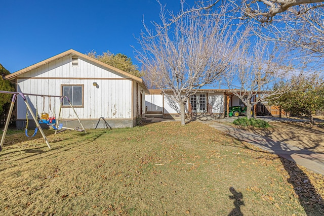 rear view of property with a lawn