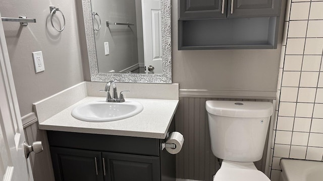 full bathroom featuring independent shower and bath, toilet, and vanity