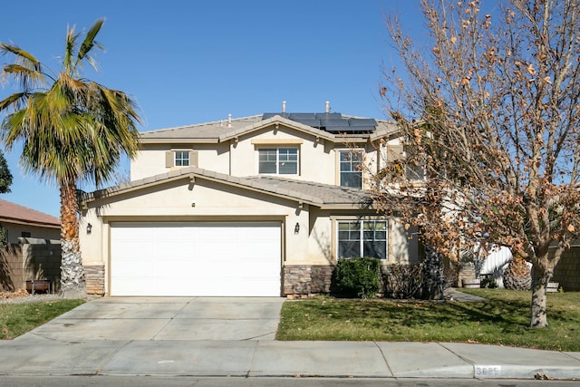 view of front of property featuring solar panels, a front lawn, and a garage