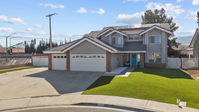 view of front of house with a garage, a front lawn, and solar panels