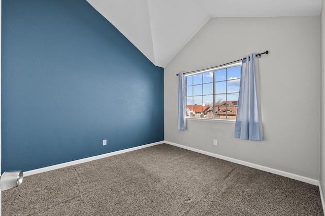 empty room featuring vaulted ceiling and carpet floors