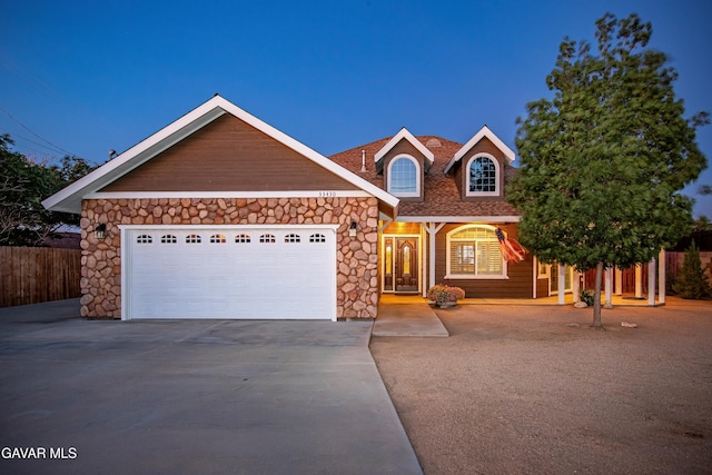 33430 E 133rd St, Pearblossom, CA 93553 - view of front of house featuring driveway, an attached garage, and stone siding