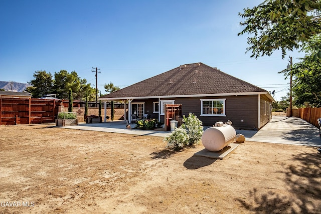 33430 E 133rd St, Pearblossom, CA 93553 - rear view of house featuring a fenced backyard, a shingled roof, and a patio