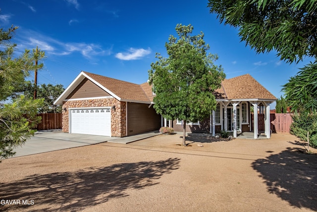 33430 E 133rd St, Pearblossom, CA 93553 - view of front of home featuring a garage, concrete driveway, and stone siding