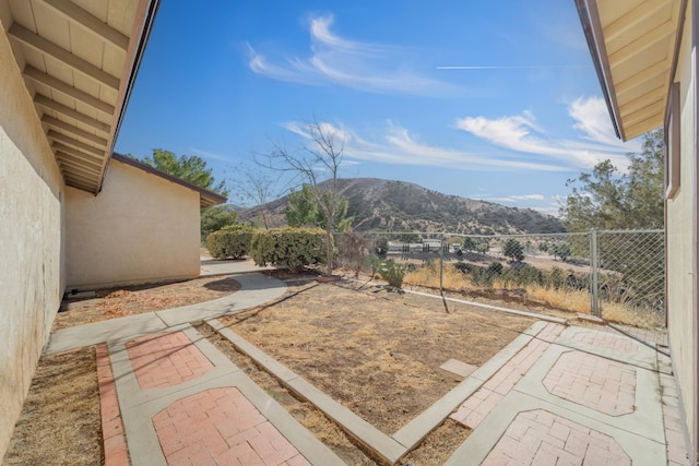 view of yard featuring a mountain view and a patio area