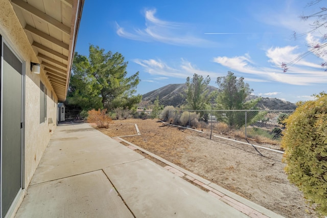 view of yard with a mountain view and a patio