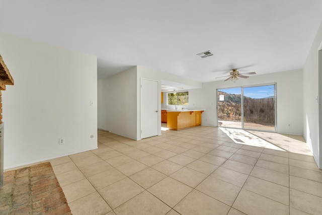 unfurnished living room featuring ceiling fan and light tile patterned floors