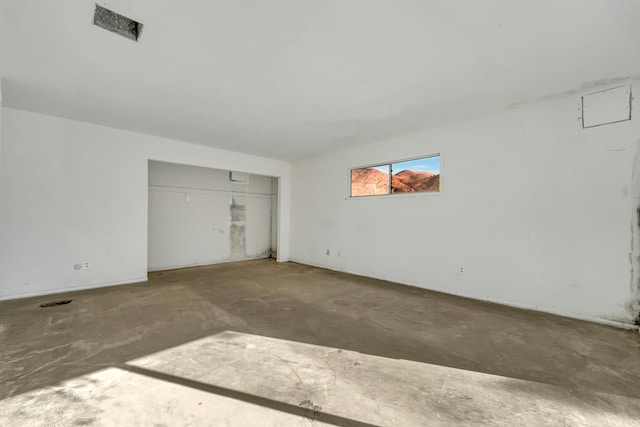 unfurnished bedroom with concrete floors and a closet