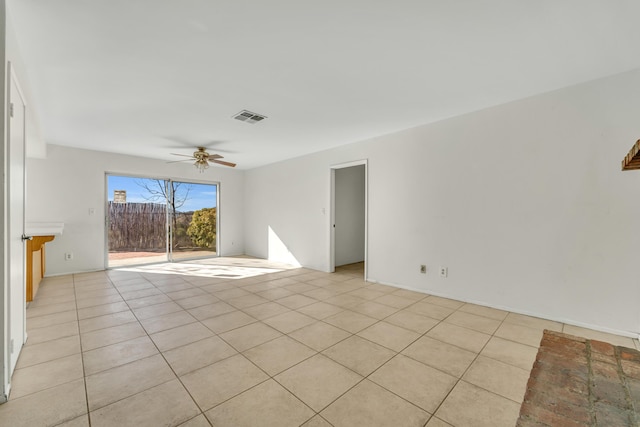 spare room featuring ceiling fan and light tile patterned floors