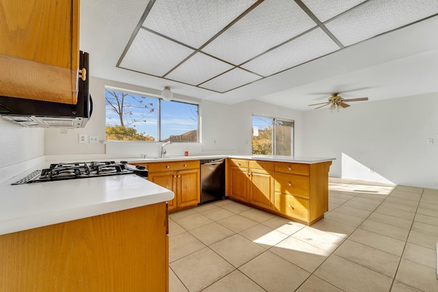 kitchen featuring ceiling fan, dishwasher, sink, kitchen peninsula, and light tile patterned flooring