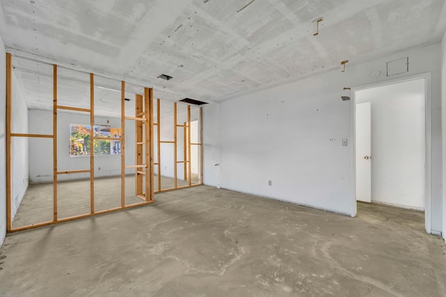 unfurnished room featuring concrete floors