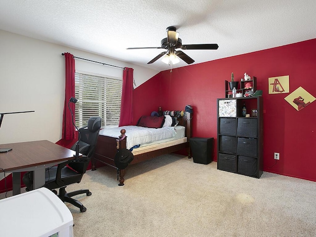 carpeted bedroom with a ceiling fan and a textured ceiling