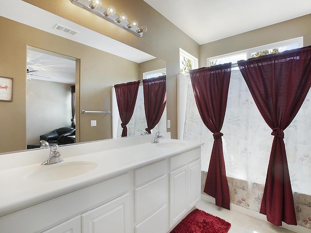 bathroom featuring visible vents, ceiling fan, a sink, and double vanity