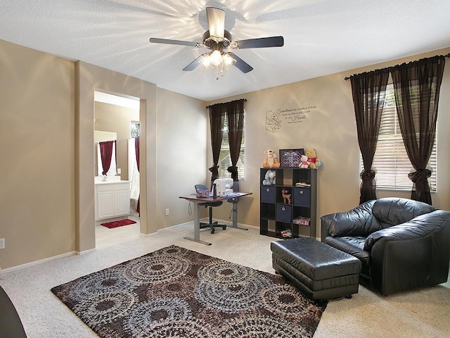 sitting room with baseboards, a healthy amount of sunlight, and ceiling fan