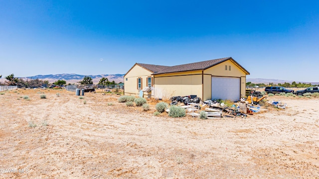 25739 Flatcreek St, Lancaster, CA 93536 - view of side of property featuring a mountain view and an attached garage