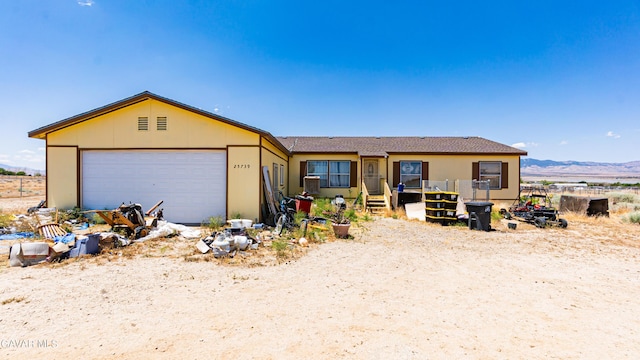 25739 Flatcreek St, Lancaster, CA 93536 - view of front facade featuring an attached garage, a mountain view, and stucco siding