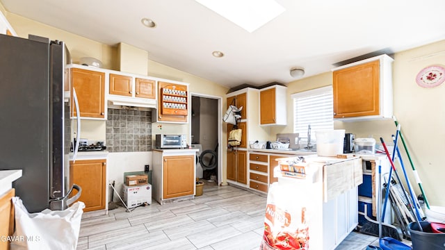 25739 Flatcreek St, Lancaster, CA 93536 - kitchen with freestanding refrigerator, tasteful backsplash, vaulted ceiling, light countertops, and recessed lighting
