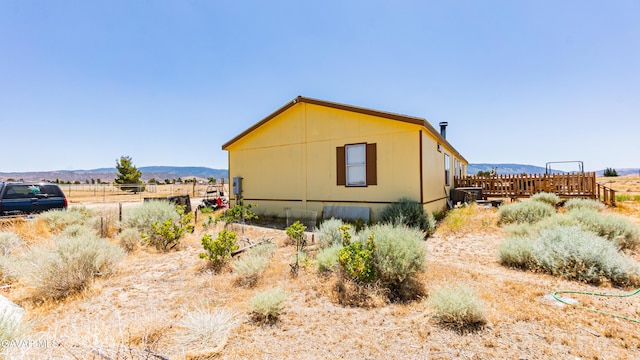 25739 Flatcreek St, Lancaster, CA 93536 - view of property exterior featuring a deck with mountain view