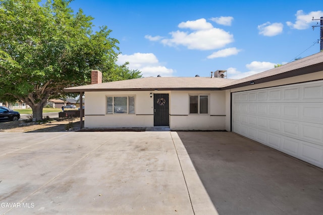 44338 W 23rd St, Lancaster, CA 93536 - ranch-style house featuring stucco siding, a chimney, driveway, and a garage