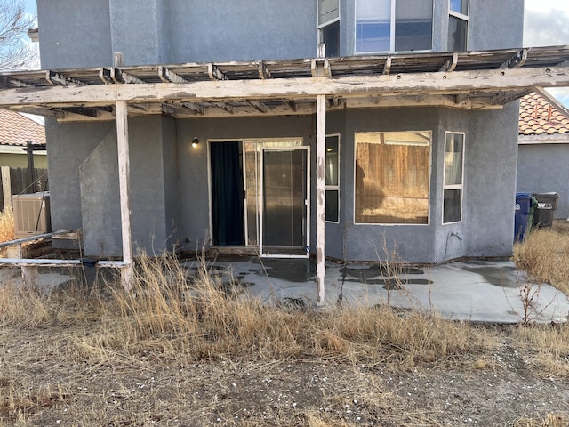 back of house with stucco siding, a patio, and a tiled roof