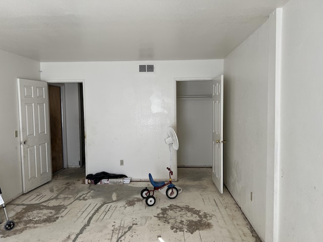 unfurnished bedroom featuring visible vents