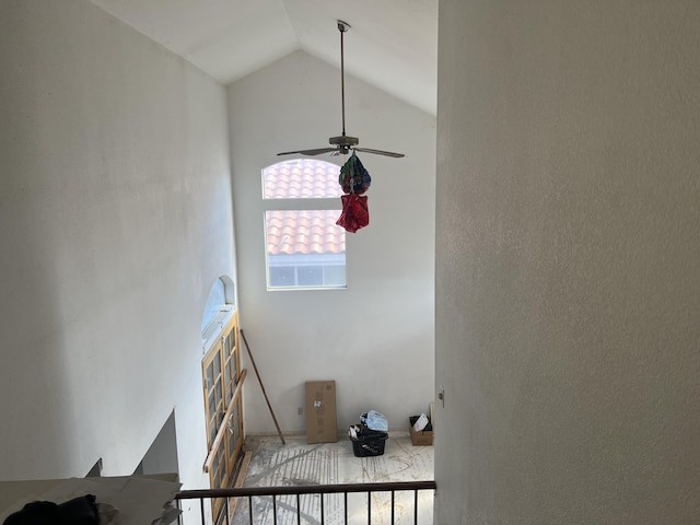 staircase with high vaulted ceiling and ceiling fan