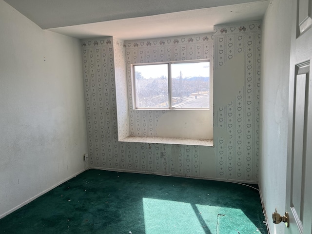 empty room with wallpapered walls, baseboards, and carpet floors