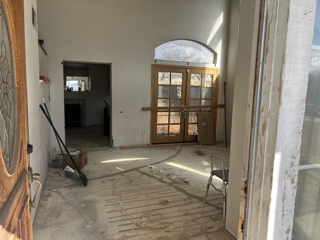 foyer featuring french doors and a high ceiling