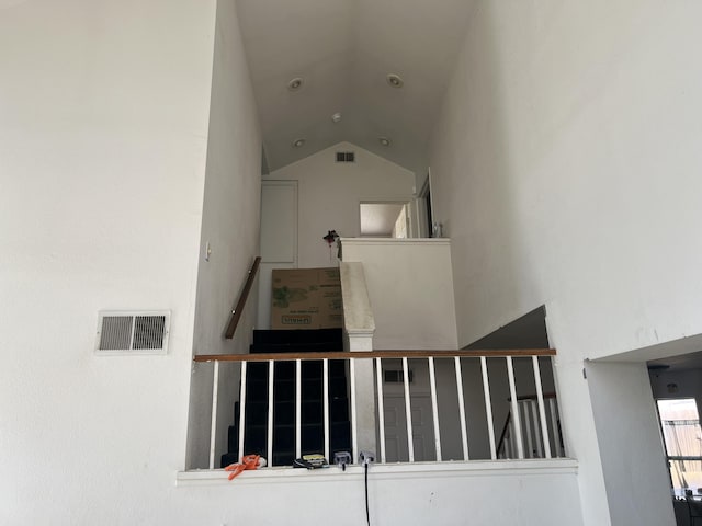 stairway with lofted ceiling and visible vents