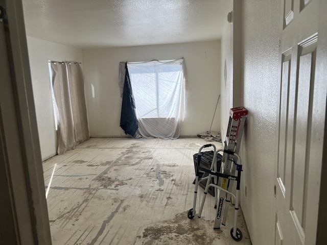 spare room with a textured ceiling