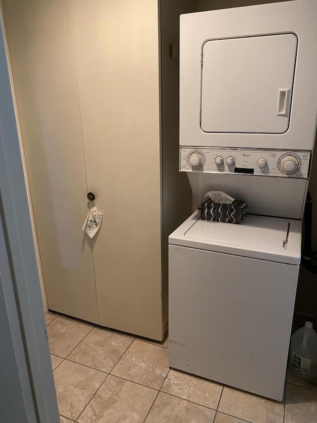 42925 W 15th St Unit 6, Lancaster, CA 93534 - clothes washing area featuring light tile patterned floors, stacked washer and clothes dryer, and laundry area