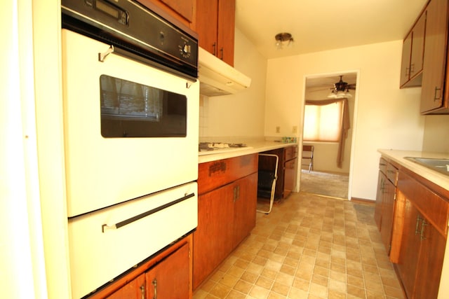45581 Sancroft Ave, Lancaster, CA 93535 - kitchen with oven, a warming drawer, light countertops, and ventilation hood