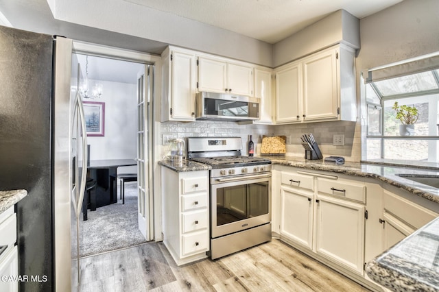 1306 Date Palm Dr, Palmdale, CA 93551 - kitchen featuring stainless steel appliances, light wood finished floors, backsplash, and light stone countertops
