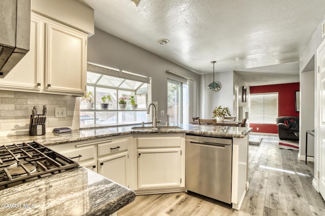 1306 Date Palm Dr, Palmdale, CA 93551 - kitchen featuring dishwasher, light wood-style flooring, a textured ceiling, backsplash, and light stone counters