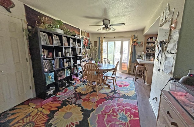 interior space with a textured ceiling and a ceiling fan