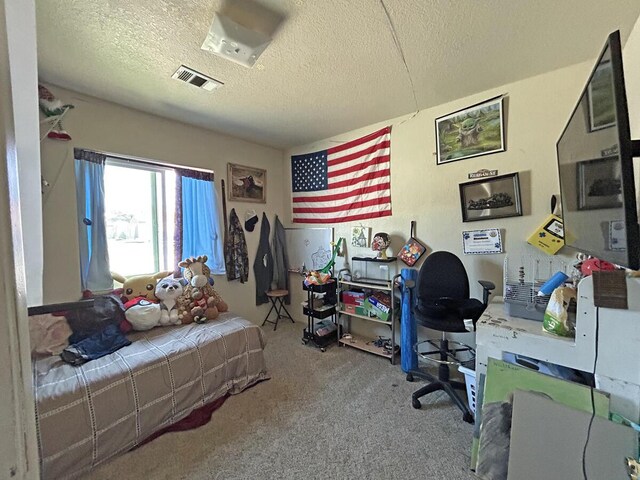 carpeted bedroom with a textured ceiling and visible vents