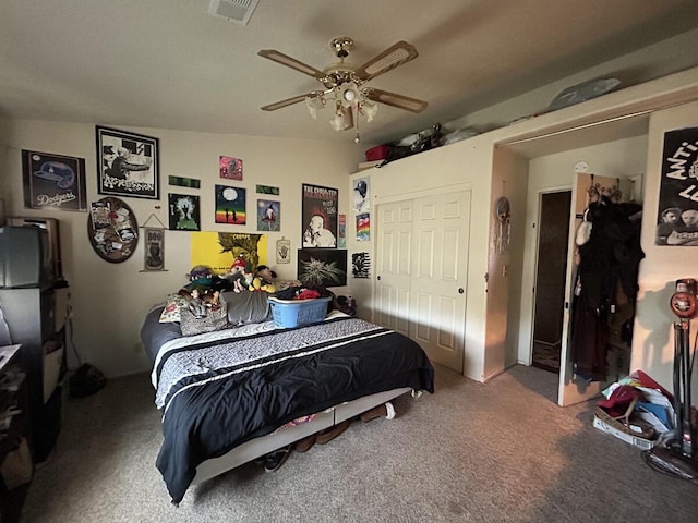 carpeted bedroom featuring visible vents and a ceiling fan