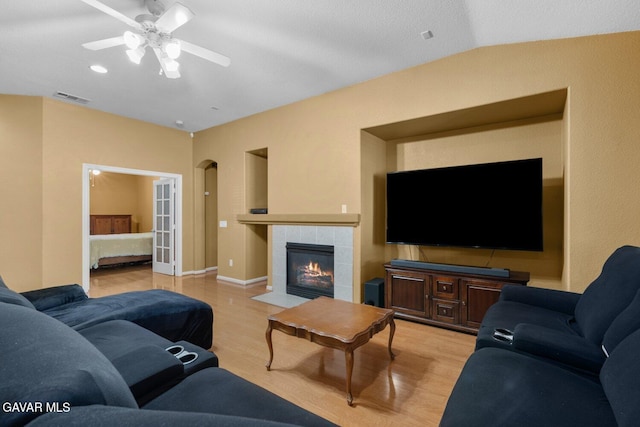 38160 Antibes Dr, Palmdale, CA 93552 - living area with light wood finished floors, a ceiling fan, lofted ceiling, and a tiled fireplace