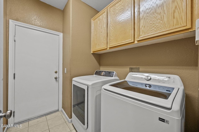 38160 Antibes Dr, Palmdale, CA 93552 - laundry area with cabinet space, washer and dryer, a textured wall, and light tile patterned floors