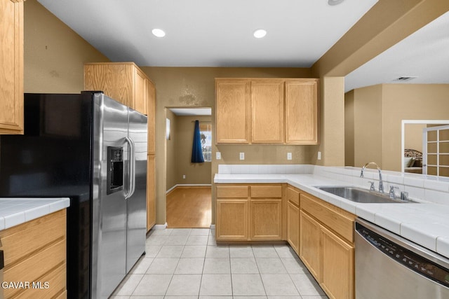 38160 Antibes Dr, Palmdale, CA 93552 - kitchen featuring stainless steel appliances, light tile patterned flooring, tile countertops, light brown cabinetry, and recessed lighting