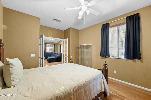 38160 Antibes Dr, Palmdale, CA 93552 - bedroom featuring wood finished floors, french doors, and ceiling fan