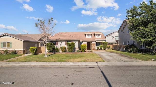 38160 Antibes Dr, Palmdale, CA 93552 - view of front facade with concrete driveway, a tiled roof, stucco siding, and stone siding