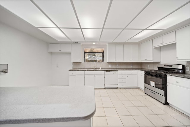 kitchen featuring stainless steel gas stove, a sink, white cabinetry, decorative backsplash, and dishwasher