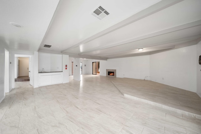 basement with visible vents and a warm lit fireplace