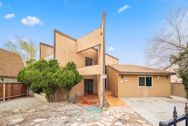 rear view of property with a patio and fence