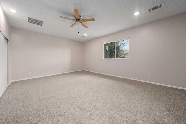 empty room featuring recessed lighting, visible vents, carpet flooring, and a ceiling fan