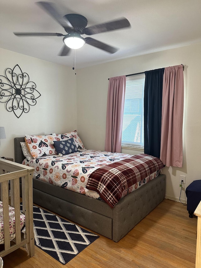 bedroom featuring ceiling fan and light hardwood / wood-style flooring